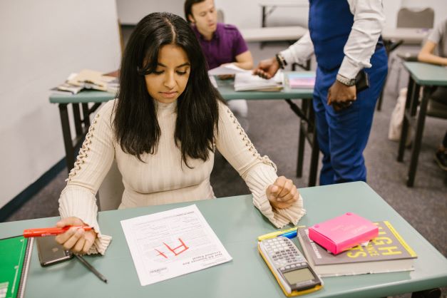 student seeing her result on a table.