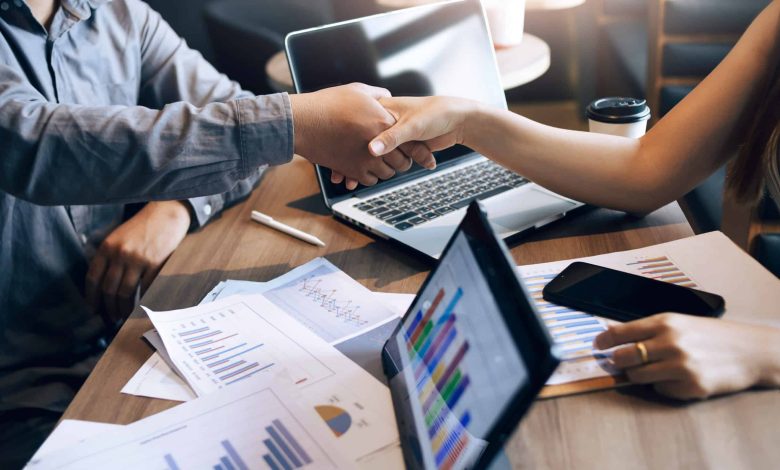 A dynamic team of marketing professionals strategizing around a conference table, surrounded by digital marketing metrics and creative concepts.